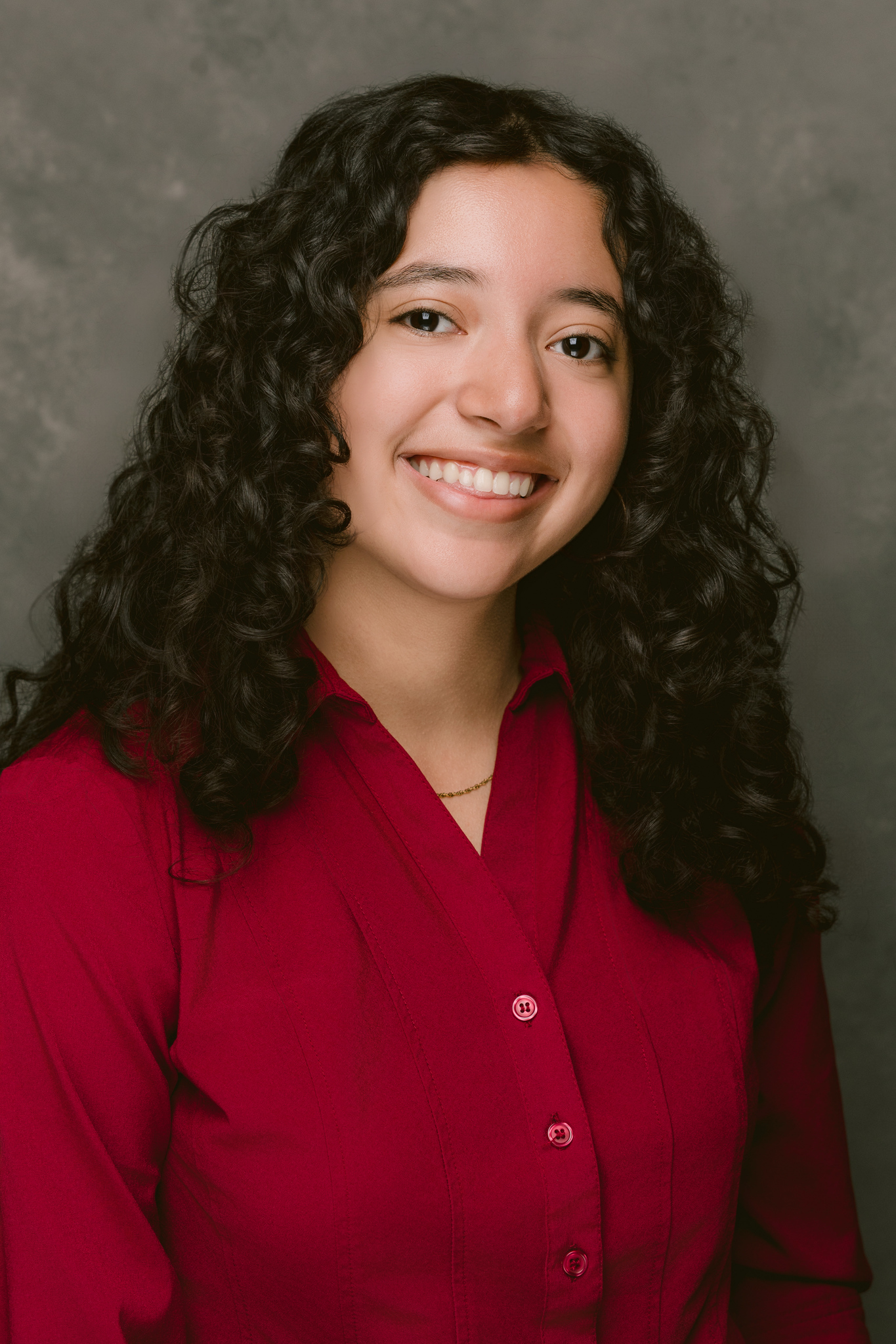 My headshot, where I am wearing a red button up shirt.