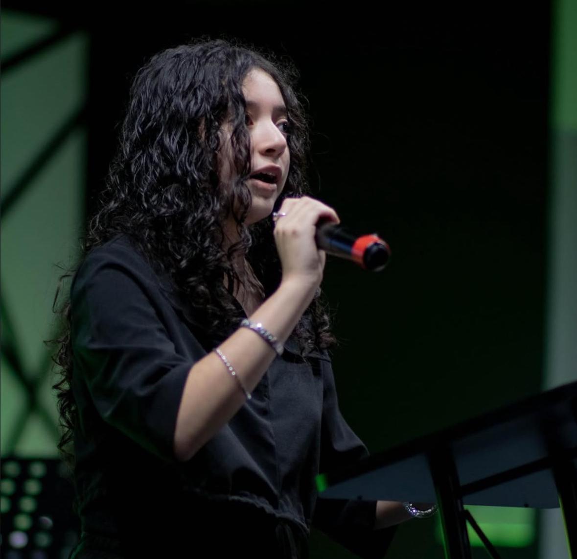 Me on stage at my church preaching into a microphone.